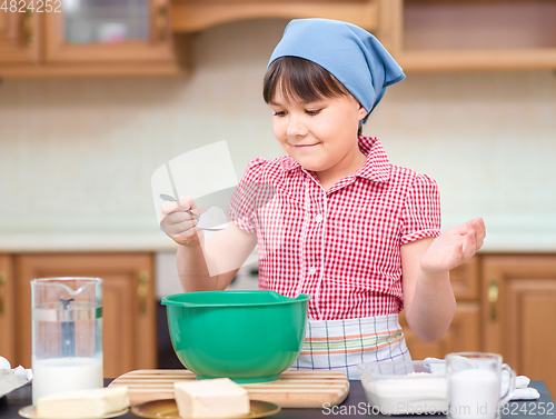 Image of Girl is cooking in kitchen