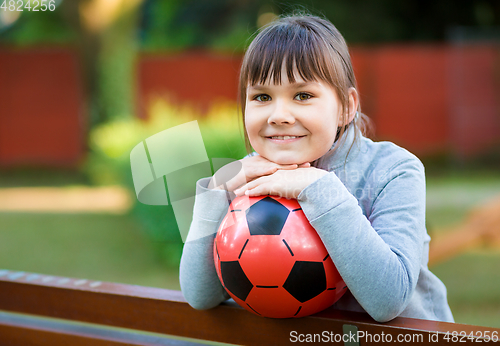 Image of Cute little girl is playing in playground