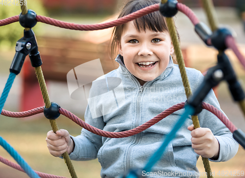 Image of Cute little girl is playing in playground