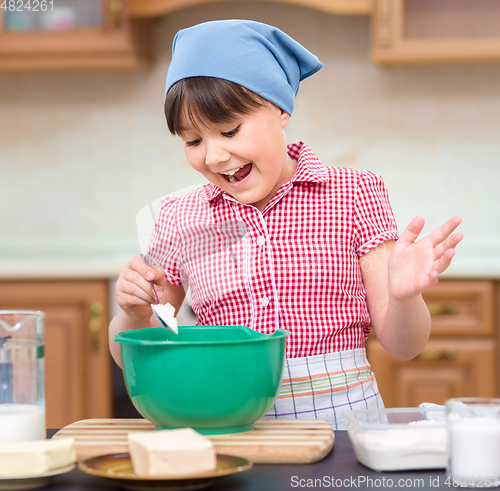 Image of Girl is cooking in kitchen