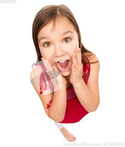 Image of Little girl is holding her face in astonishment