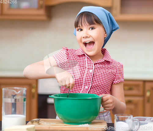 Image of Girl is cooking in kitchen