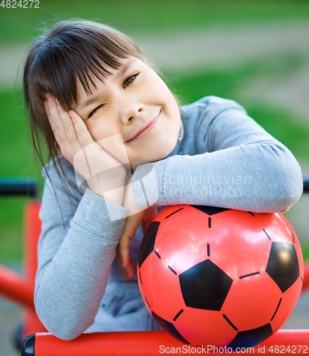 Image of Cute little girl is playing in playground