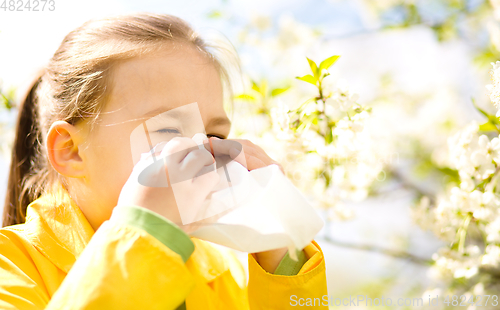 Image of Little girl is blowing her nose