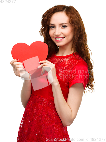 Image of Young woman holding red heart