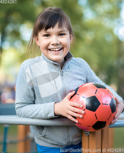 Image of Cute little girl is playing in playground