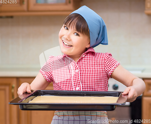 Image of Girl is cooking in kitchen