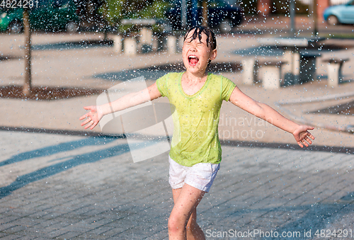 Image of Girl is running through fountains