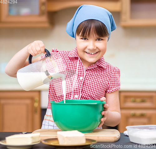 Image of Girl is cooking in kitchen