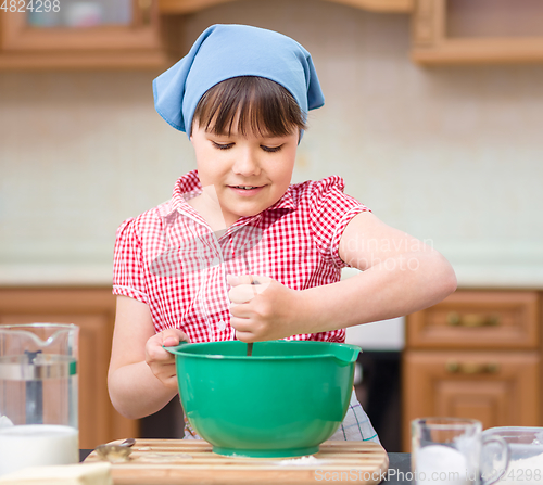 Image of Girl is cooking in kitchen