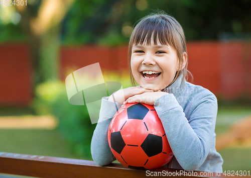 Image of Cute little girl is playing in playground