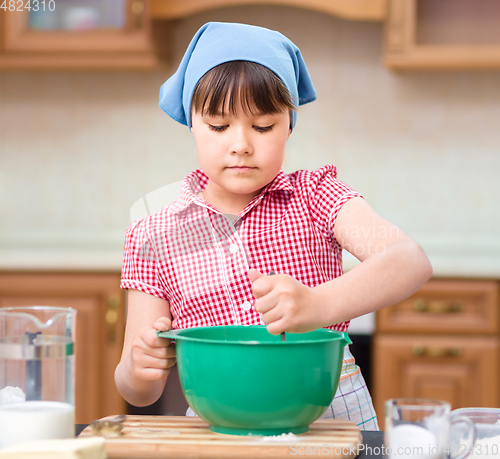Image of Girl is cooking in kitchen