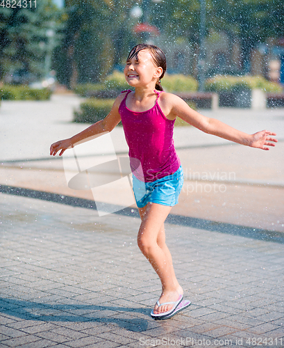 Image of Girl is running through fountains