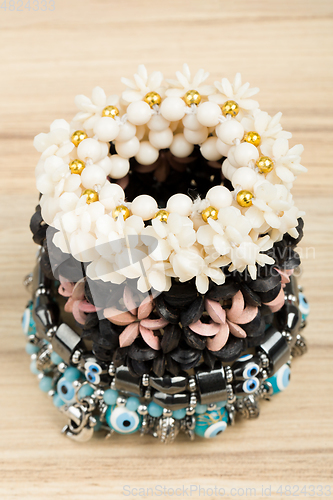 Image of woman bracelet on wooden background