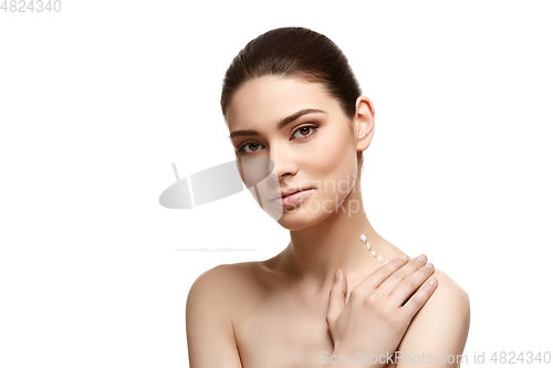 Image of girl applying moisturizing cream isolated on white