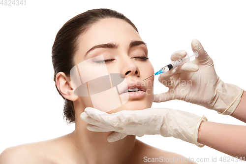Image of girl getting face injection isolated on white