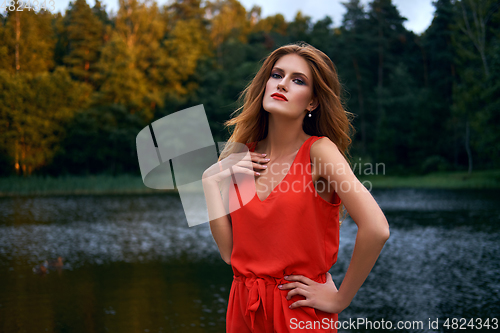 Image of beautiful girl wiith red lips near lake