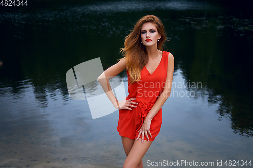 Image of beautiful girl wiith red lips near lake