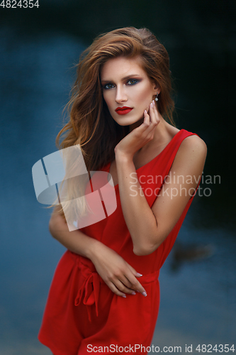 Image of beautiful girl wiith red lips near lake