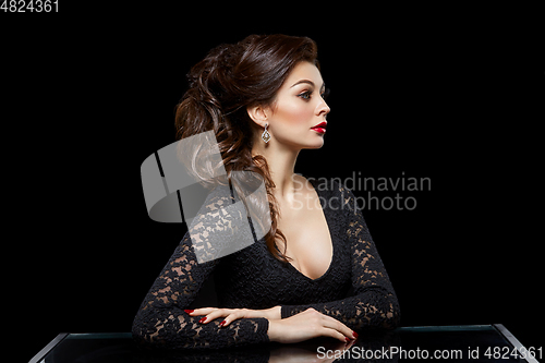 Image of beautiful young woman with red lips on black