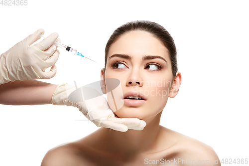 Image of girl getting face injection isolated on white