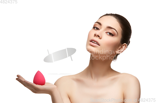 Image of girl with makeup sponge isolated on white