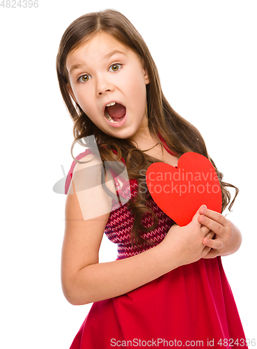 Image of Little girl is holding red heart
