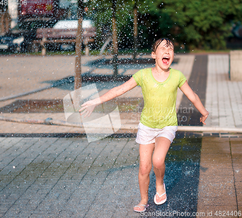 Image of Girl is running through fountains