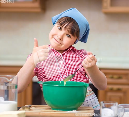 Image of Girl is cooking in kitchen