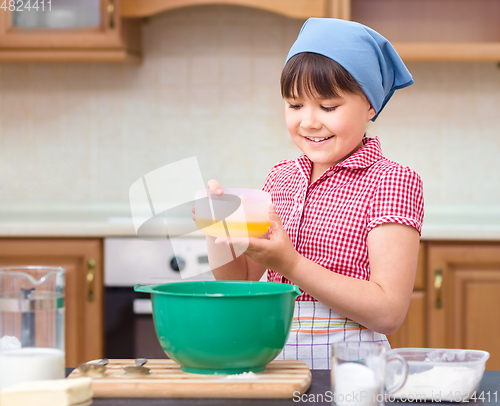 Image of Girl is cooking in kitchen