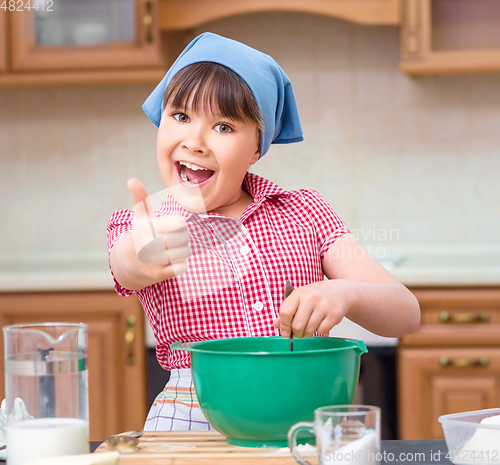 Image of Girl is cooking in kitchen