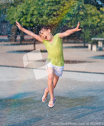 Image of Girl is running through fountains