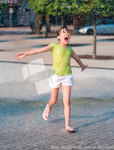 Image of Girl is running through fountains