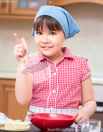 Image of Girl is cooking in kitchen