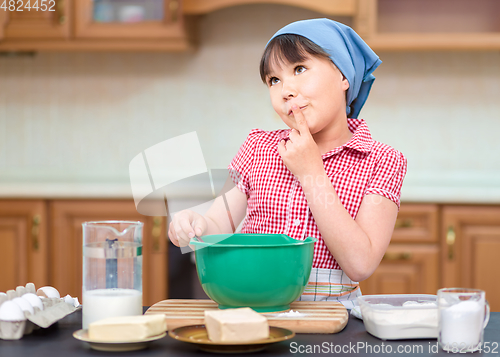 Image of Girl is cooking in kitchen