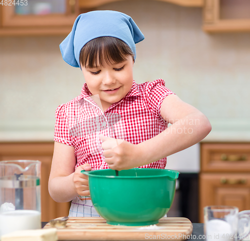 Image of Girl is cooking in kitchen