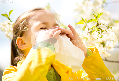 Image of Little girl is blowing her nose