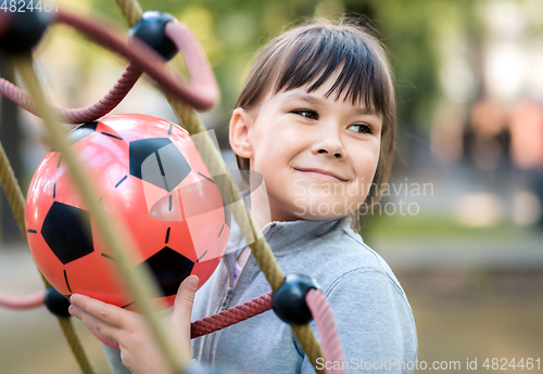 Image of Cute little girl is playing in playground