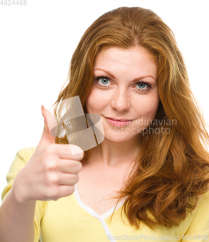 Image of Woman is showing thumb up gesture