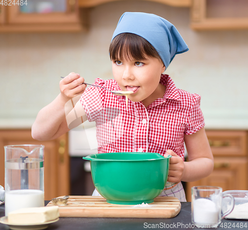Image of Girl is cooking in kitchen