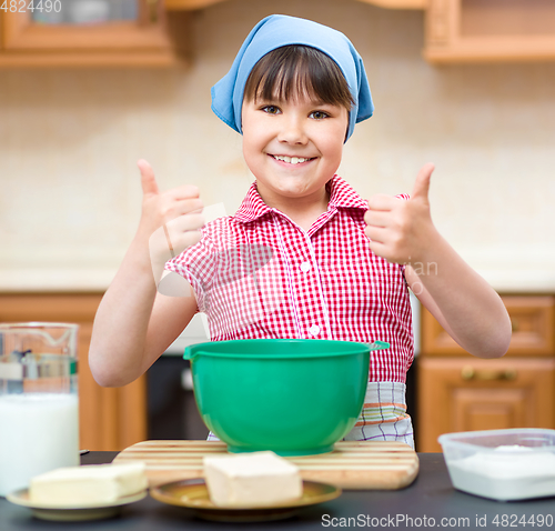 Image of Girl is cooking in kitchen