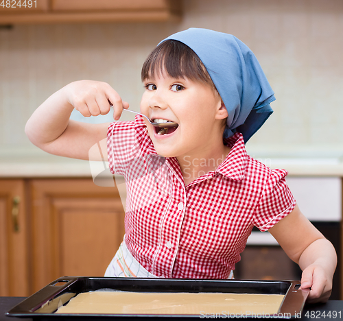 Image of Girl is cooking in kitchen