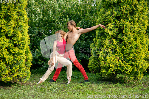 Image of beautiful modern ballet couple dancing in summer outdoors