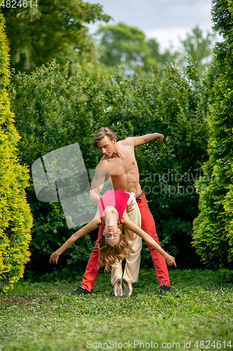 Image of beautiful modern ballet couple dancing in summer outdoors