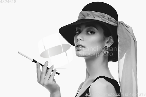 Image of beautiful young woman in retro style with cigarette