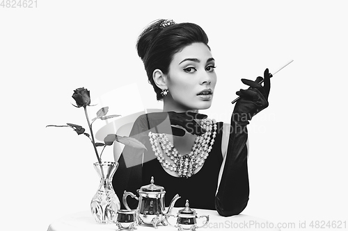 Image of beautiful young woman in retro style with cigarette