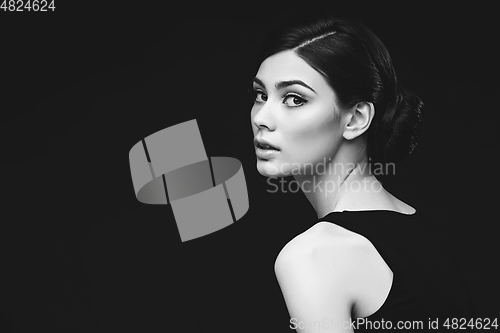 Image of beautiful girl with hairdo on balck background