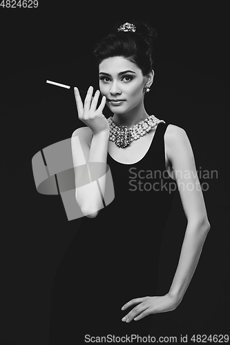 Image of beautiful young woman in retro style with cigarette