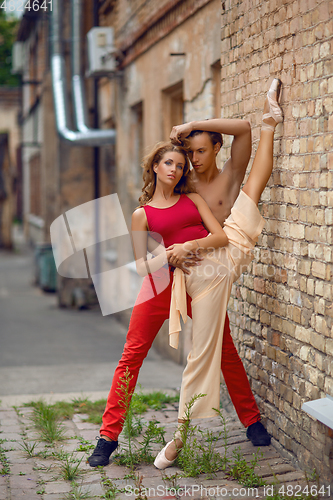 Image of beautiful modern ballet couple dancing in summer outdoors