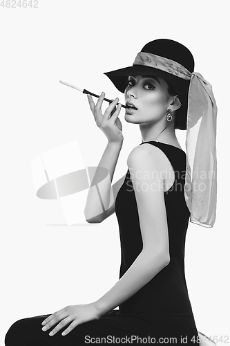 Image of beautiful young woman in retro style with cigarette